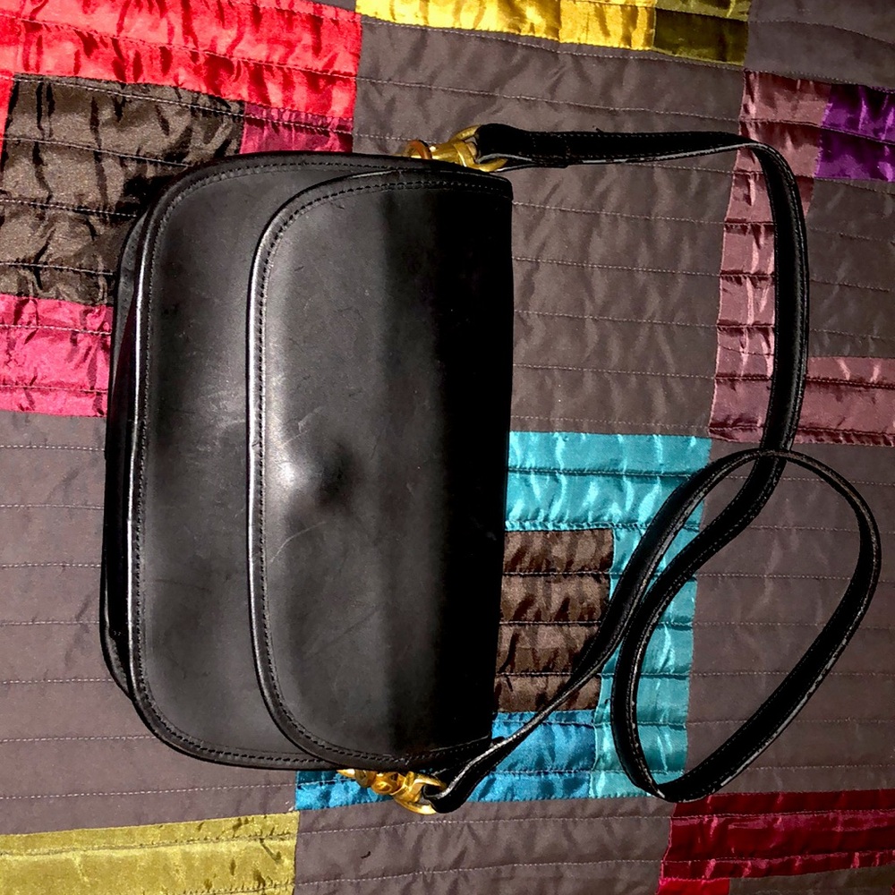 COACH Black shoulder bag with brass hook attachment.
